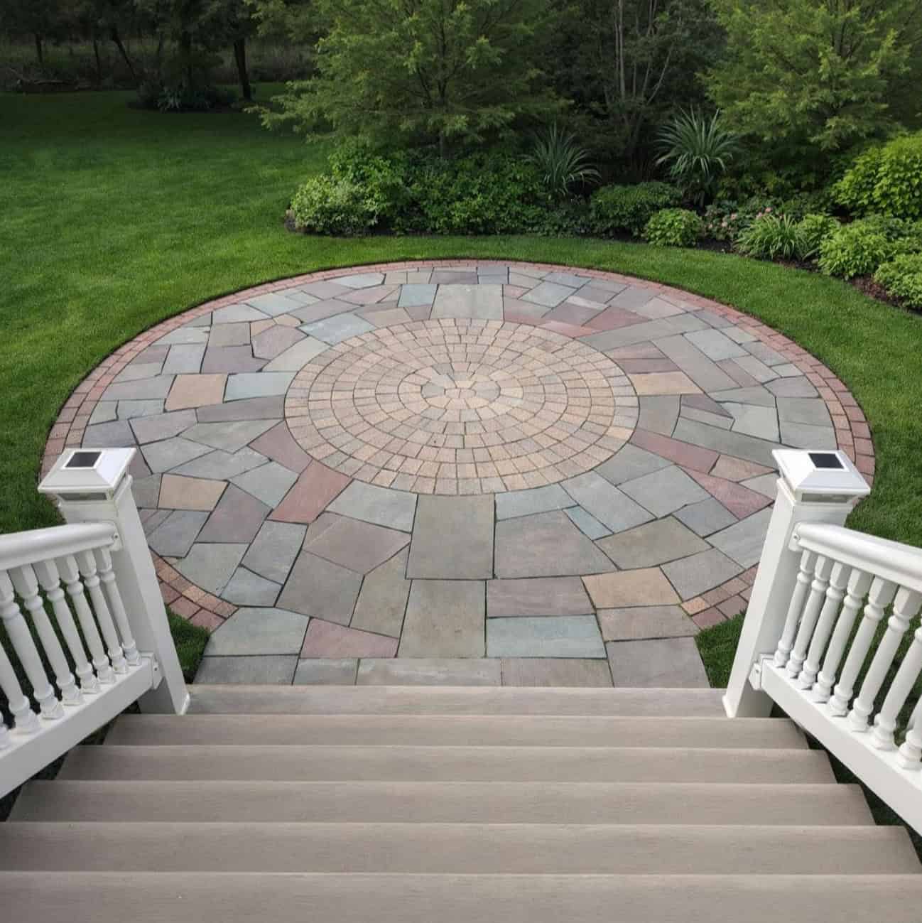 Custom circular paver patio with decorative center installed by hardscape contractor in Torrington Connecticut serving Northwest CT, Western Massachusetts, and Eastern New York.